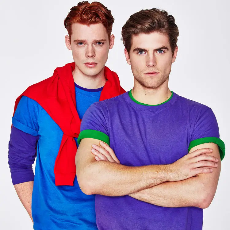 Two young men in colorful Keya uniforms and tees look casual and comfy