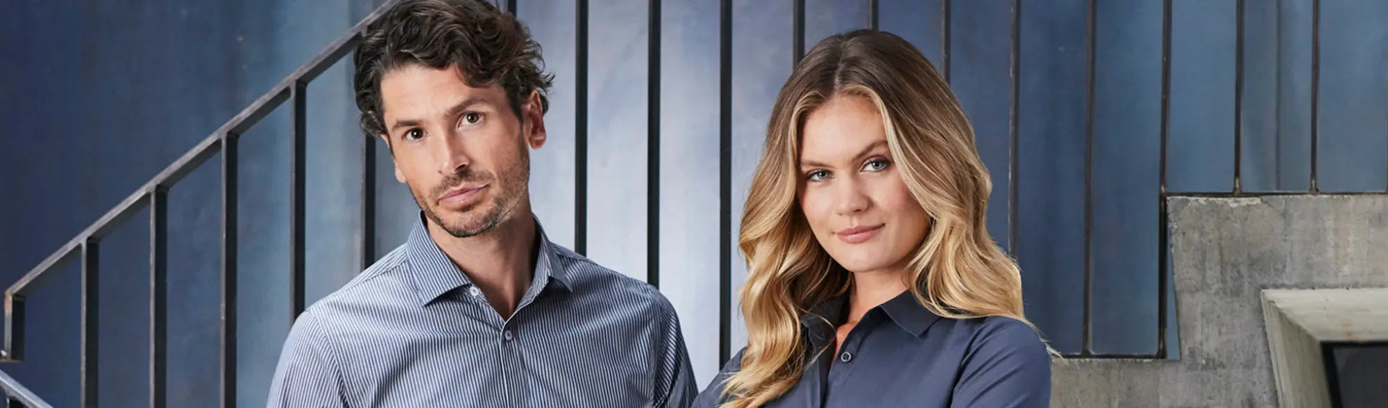 Two people in matching blue work uniforms, perfect workwear for team unity in APPAREL collection