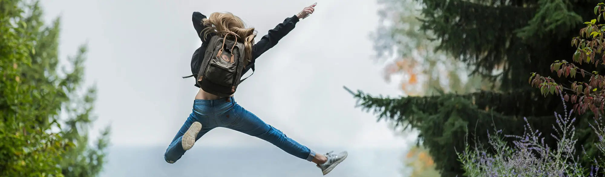 Jumping woman with backpack from Backpacks collection, perfect for casual workwear or uniforms