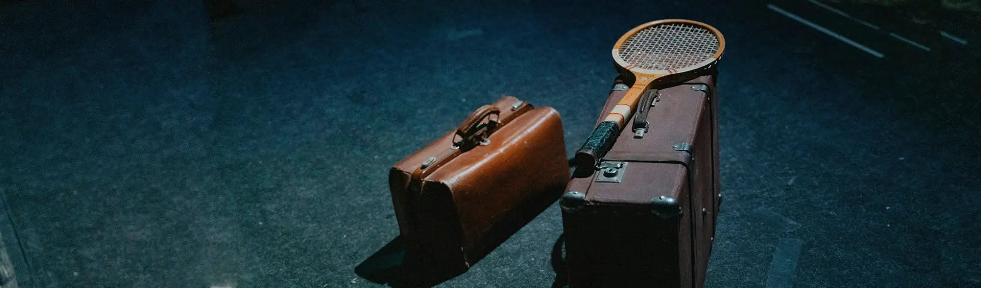 Vintage luggage and tennis racket in collection of Laptop Bags for stylish workwear