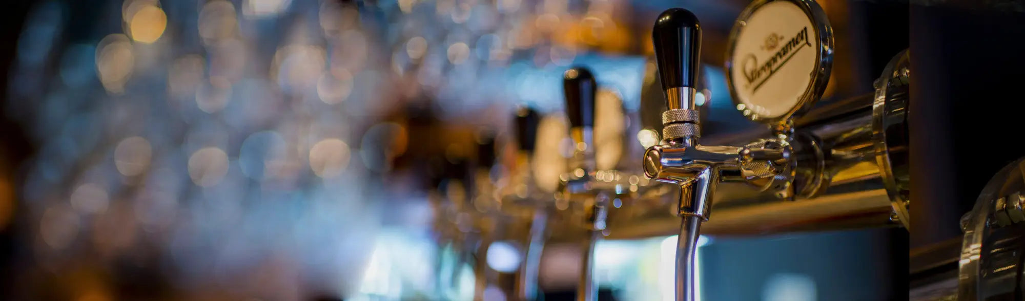 Colorful beer tap handles displayed for custom stubby holders collection