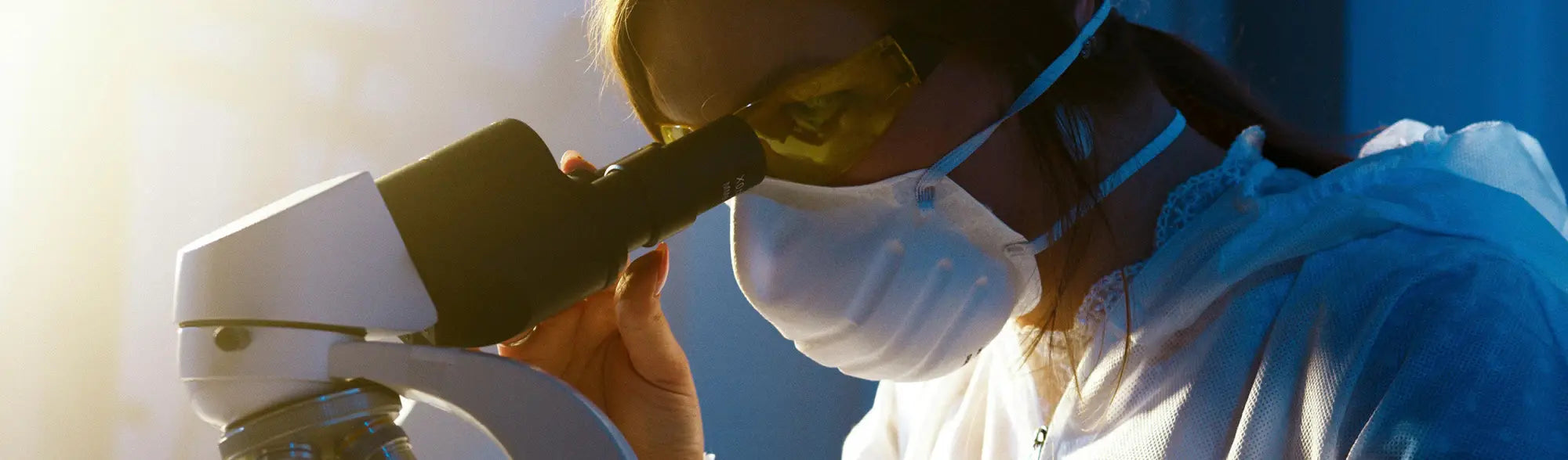 Scientist using microscope for PPE Site Safety and site safety solutions research