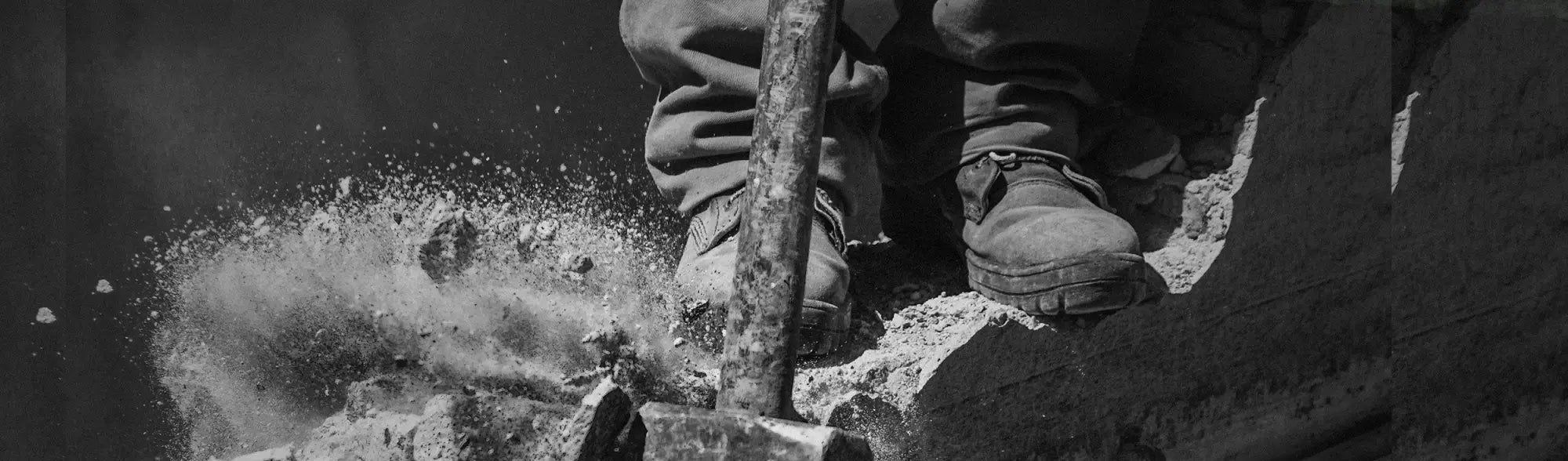 Construction worker with jackhammer in premium quality waders for tough outdoor work