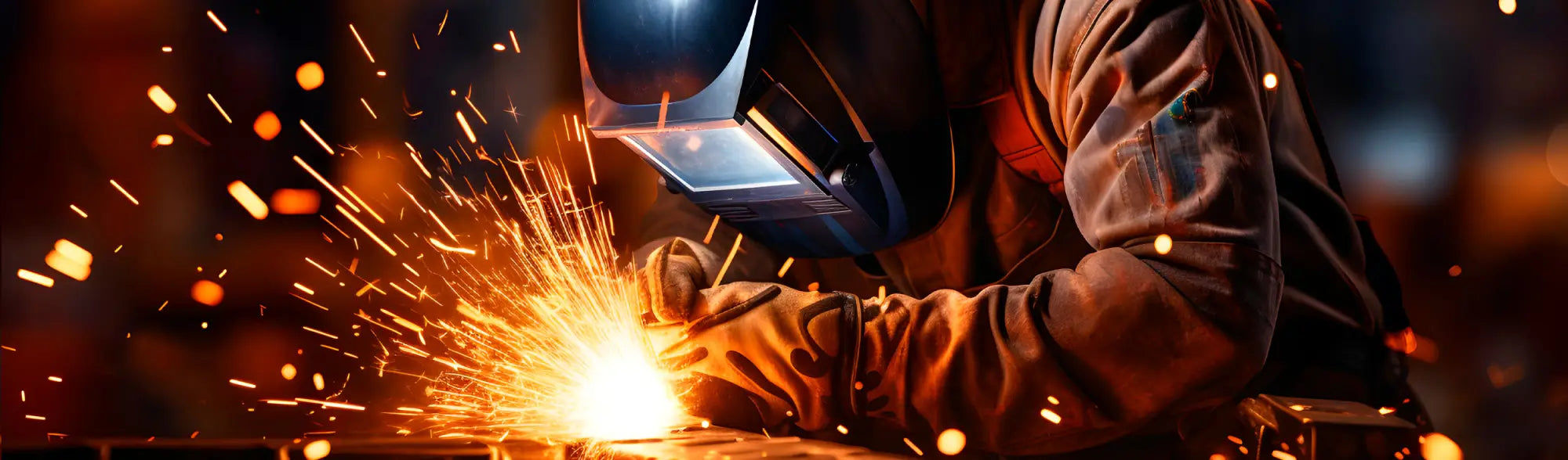 Welder with protective gear sparks showcasing PPE welding gloves and workwear professionalism