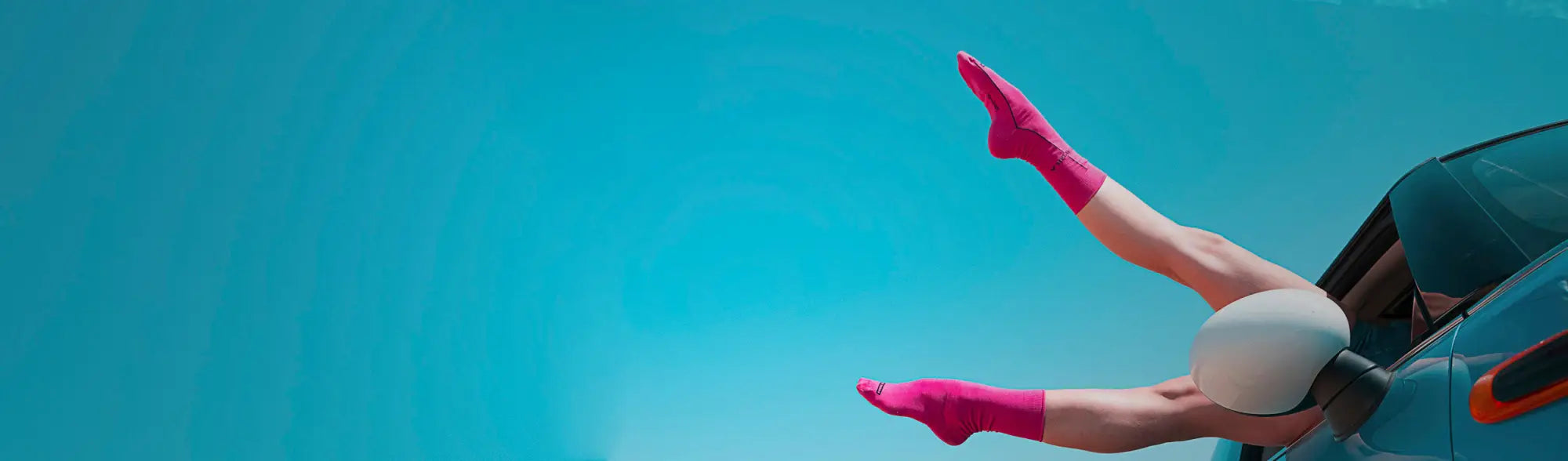 Legs in pink socks sticking out of a car window in a School Socks collection featuring school uniforms