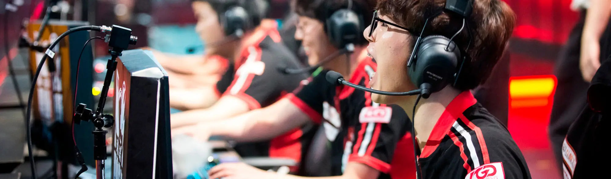 Esports team members in uniforms wearing headsets, showcasing esports apparel and workwear