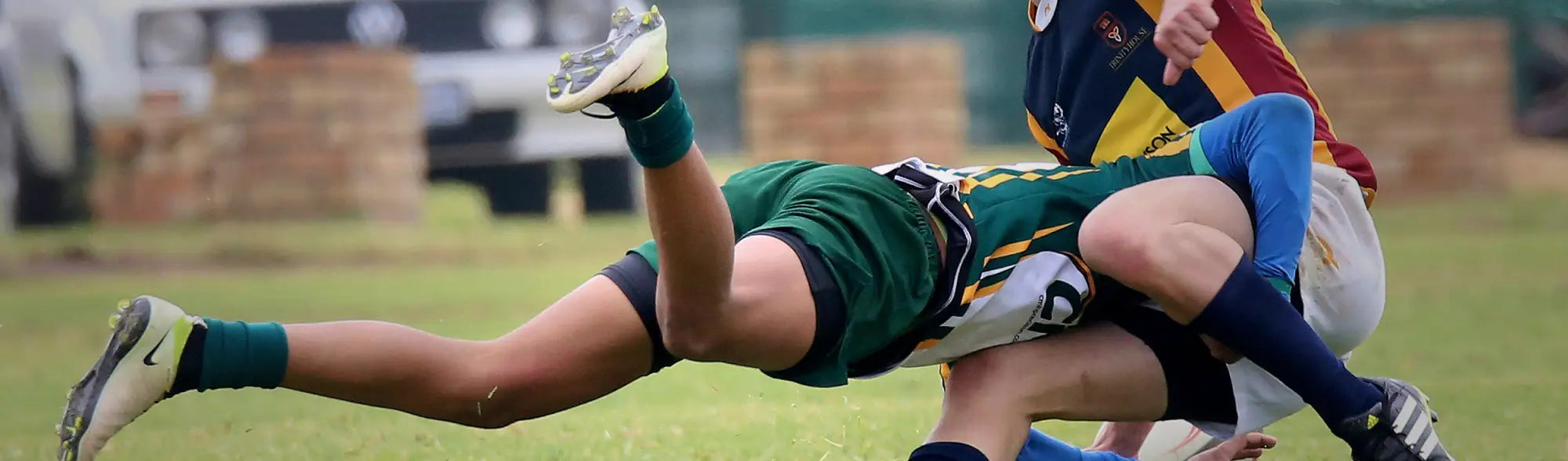 Rugby players in uniforms tackling during a game in the Sports Rugby collection