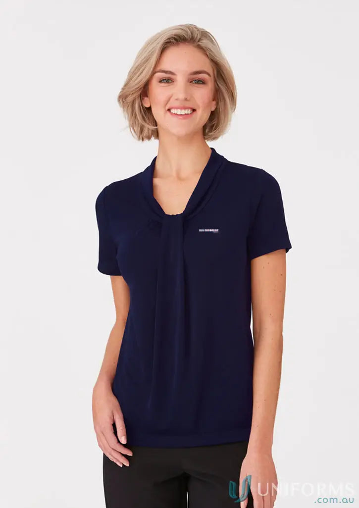 Woman in dark blue polyester matte jersey Practice Manager Ladies Top with soft draped neckline