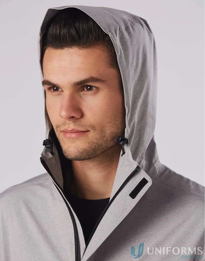Man in light grey hooded jacket from JK55 Absolute Waterproof with waterproof rating 5000mm