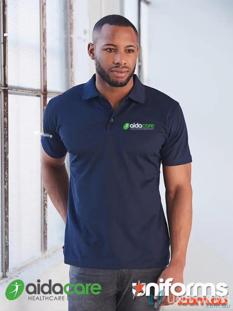 Man modeling navy blue Aidacare EMBx2 sustainable polo with green aidacare logo, perfect for work uniforms