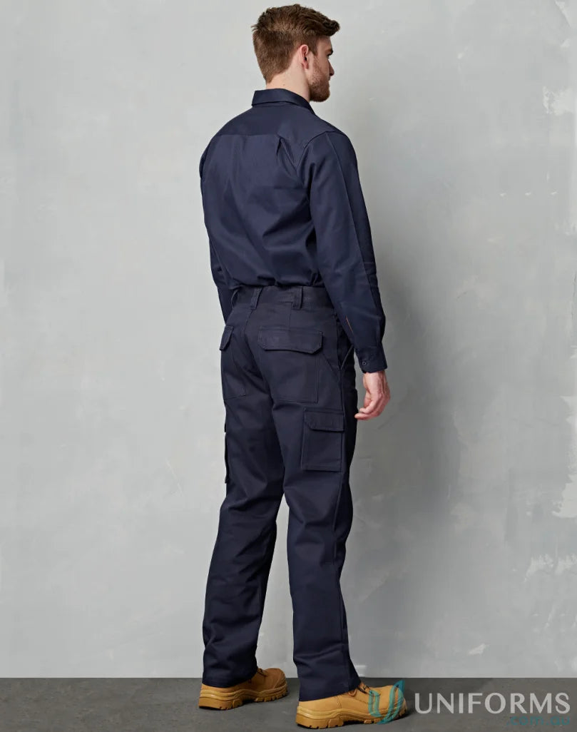 Man in navy blue AIW heavy cotton pre-shrunk drill stout pants and work boots