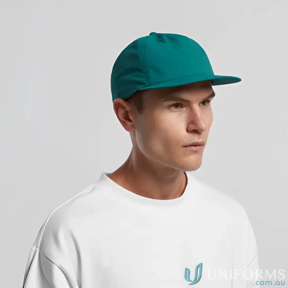 Man wearing teal surf cap made of recycled nylon with plastic snapback style