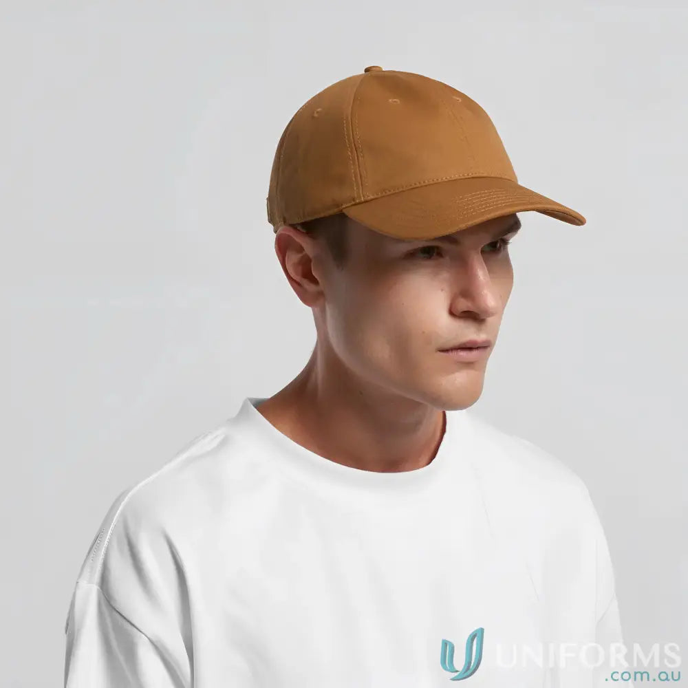 Man wearing a white T-shirt and brown Access Canvas Cap with curved peak