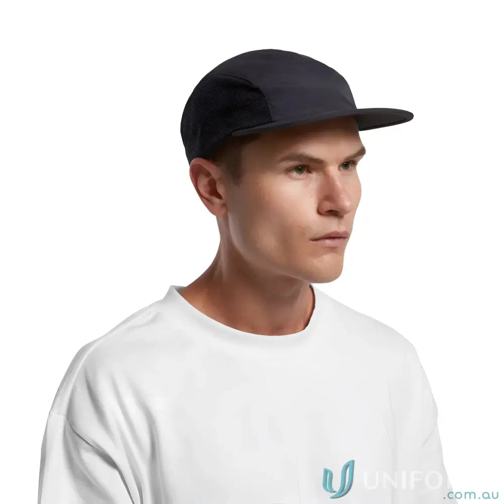 Man wearing black Colour Active Finn Cap made of recycled nylon and white tee