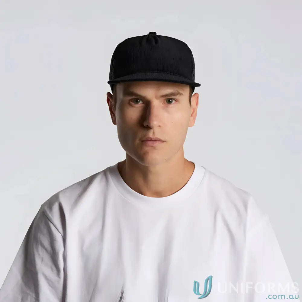 Man wearing black flat peak AS Colour Class Cord Trucker Cap in cotton 16-wale partridge