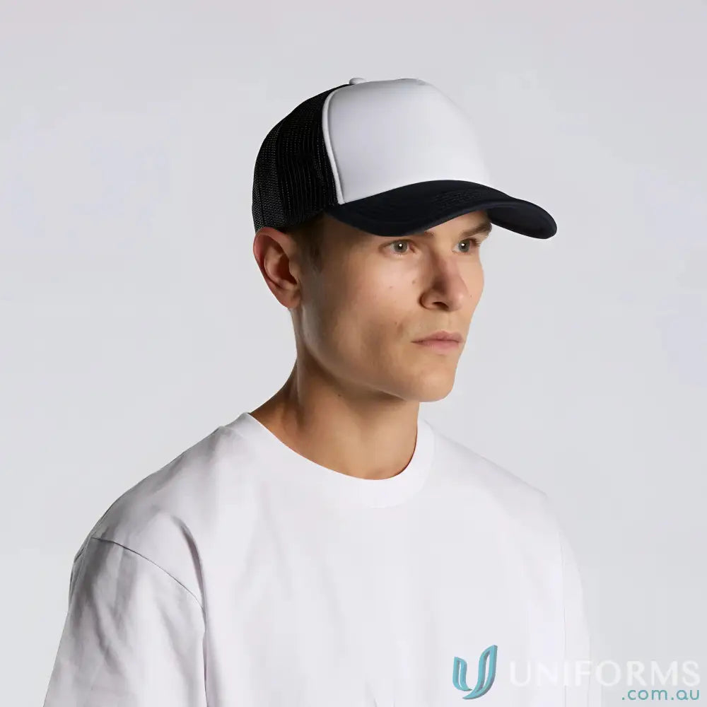 Man wearing a black and white trucker hat with curved peak and recycled polyester mesh