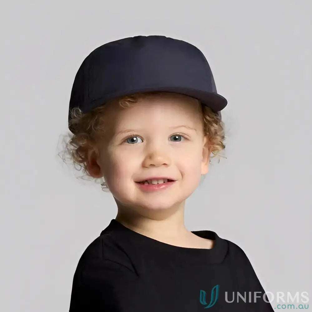 Cute toddler with curly blonde hair wearing AS Colour Kids Surf Cap with foam peak