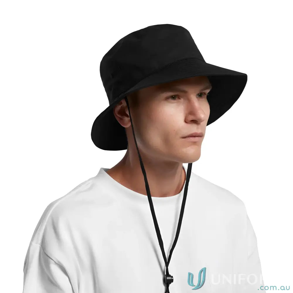 Person wearing AS Colour wide brim bucket hat with adjustable chin strap