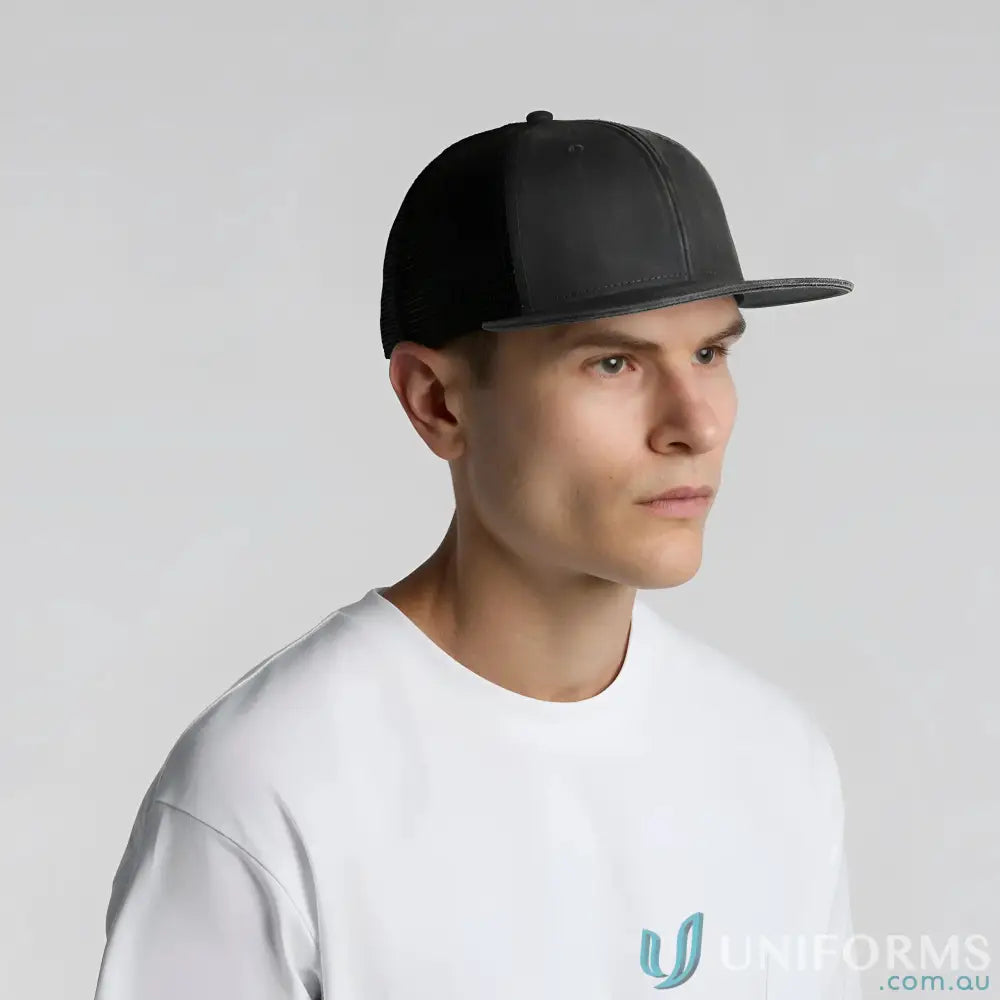 Man wearing black flat-brimmed trucker cap with durable cotton front and polyester mesh back