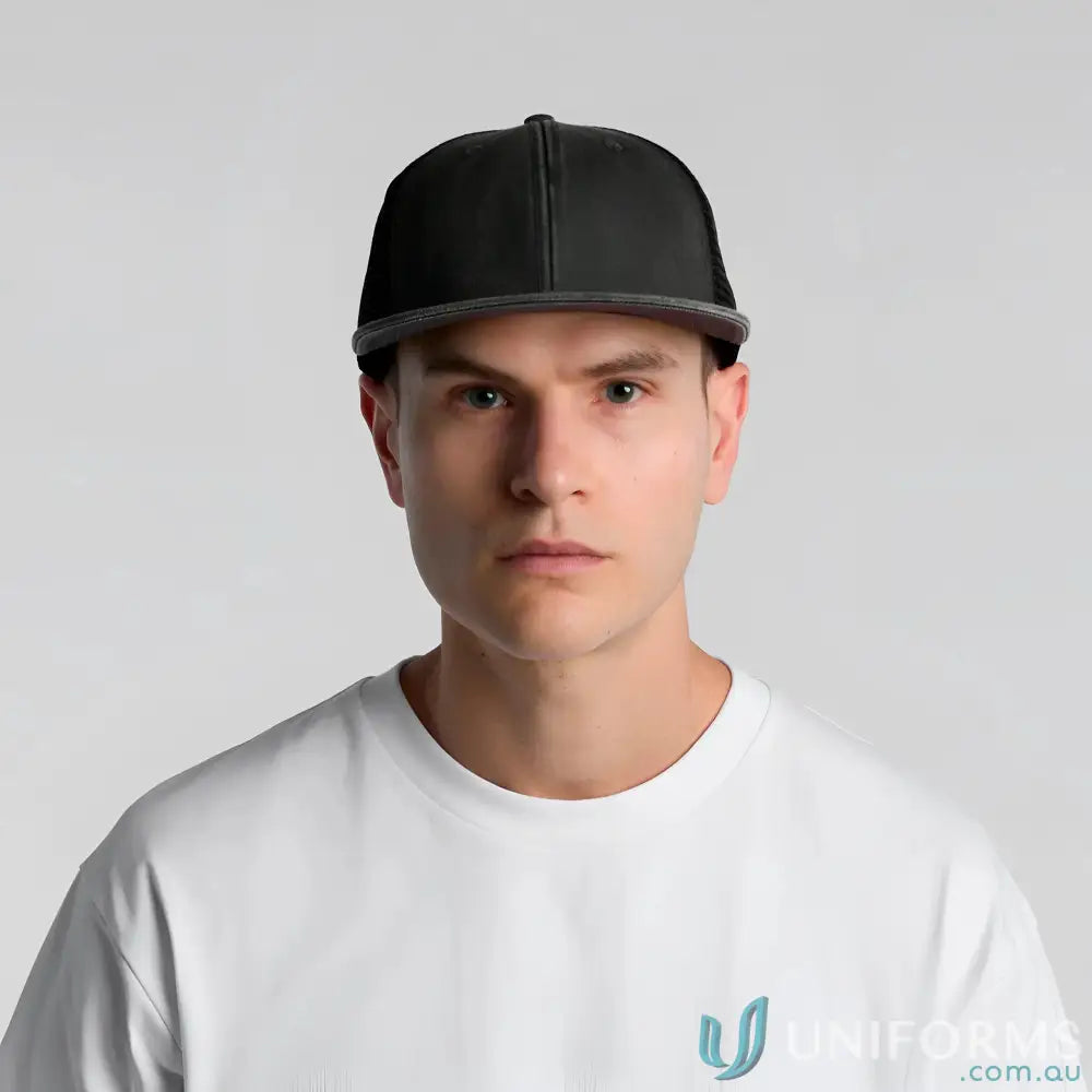 Man wearing AS Colour Stock Faded Trucker Cap with durable cotton front and polyester mesh back