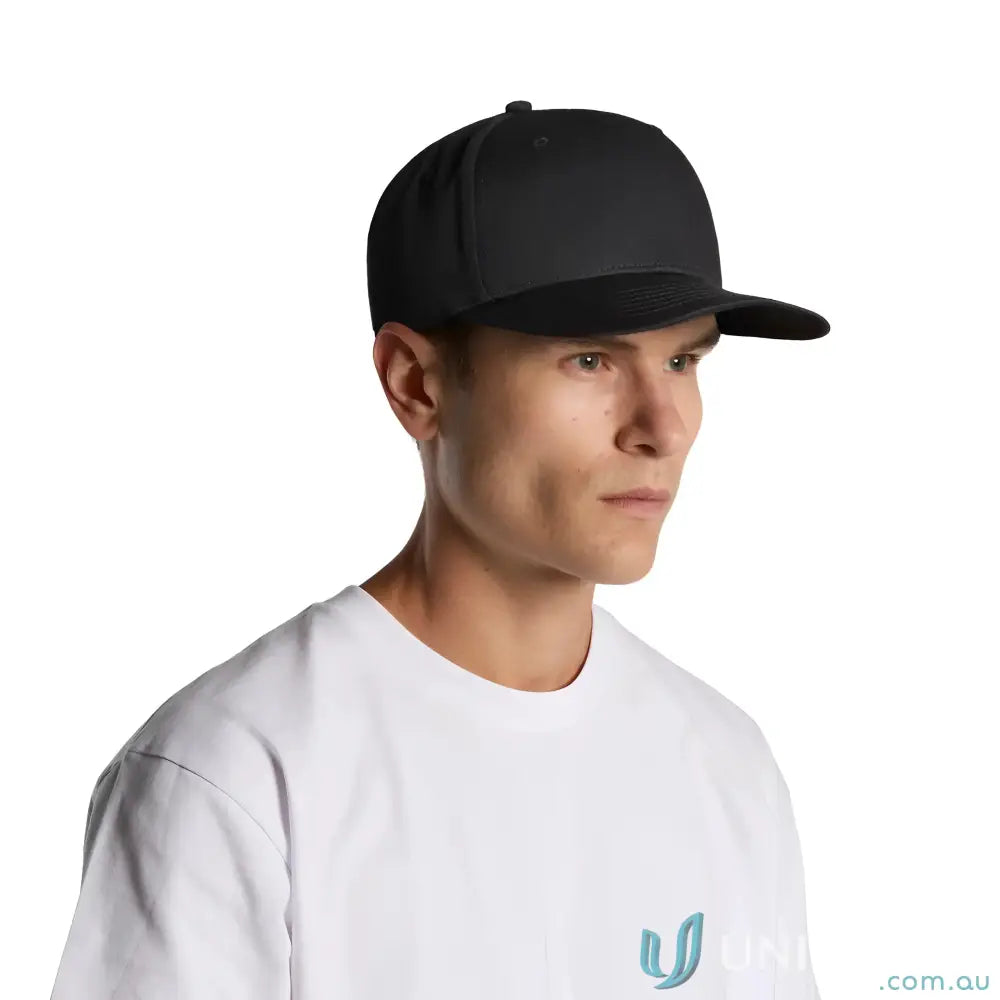 Man wearing black flat peak Colour Stock Flex Cap 1106, high profile five-panel style
