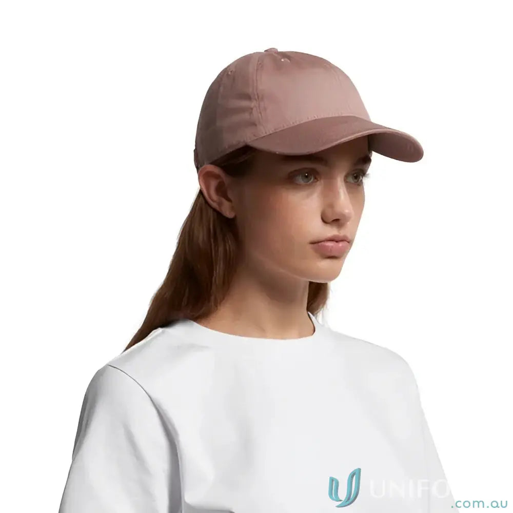Woman wearing dusty pink AS Colour Women’s Access Cap with tonal under-peak lining