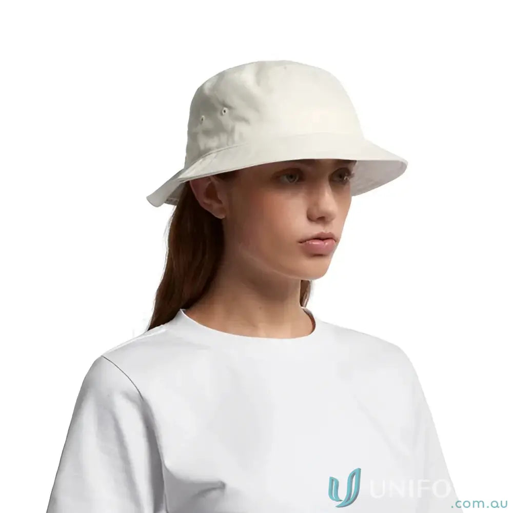 Light-colored bucket hat with reinforced brim worn by a person, perfect for summer style