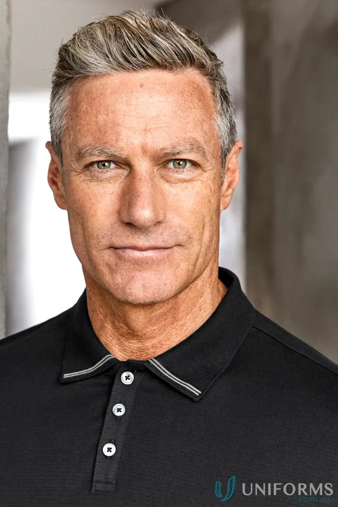 Man with gray hair and green eyes in Biz Collection Aston cotton jersey knit polo shirt