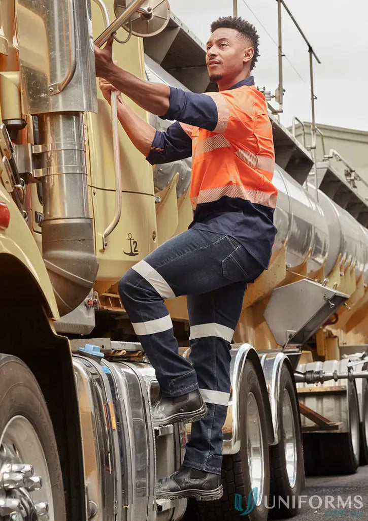 Man in bio motion taped workwear jeans climbing into a truck for tough jobs