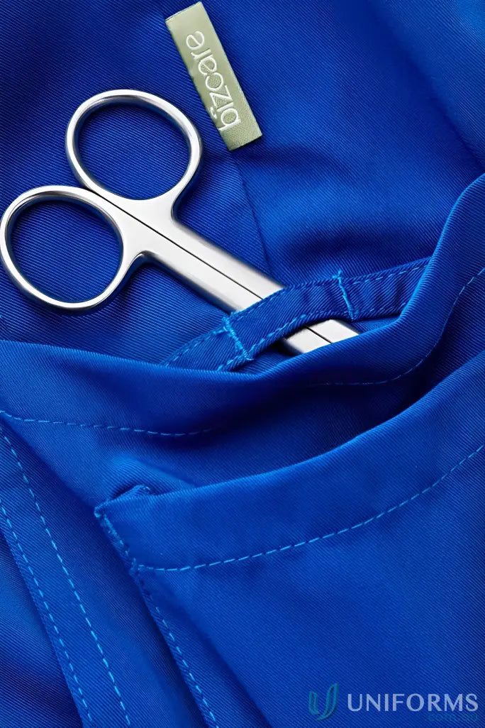 Blue Bizcare Avery Slim Leg Scrub Pant with scissors for a stylish slim leg scrub look