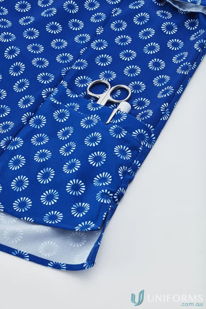 Blue patterned Bizcare women’s daisy print tunic with scissors in pocket showing easy stretch daisy feel