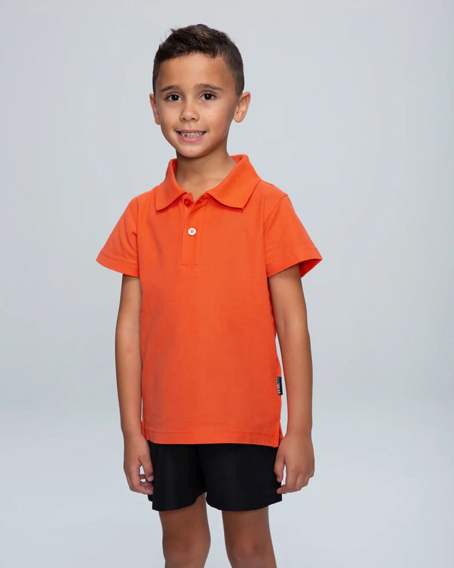 Young boy in Hunter Kids Pique Knit Polo shirt, perfect for uniforms or casual workwear