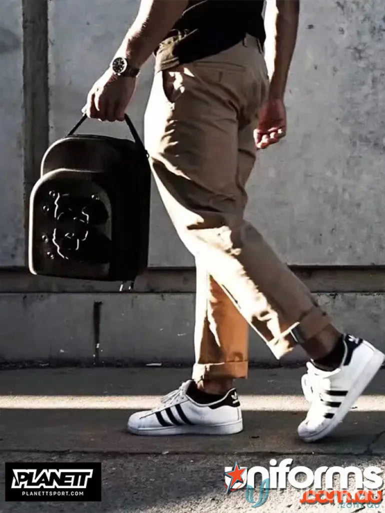 Man carrying a black Cap Hard Case Carrier for 6pk cap carrier storage