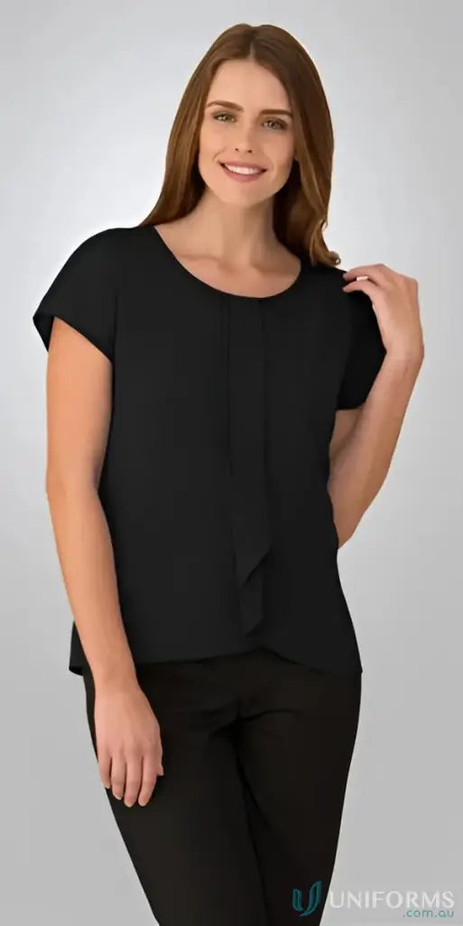 Woman in black knitted woven Cascade Top uniform style blouse and pants