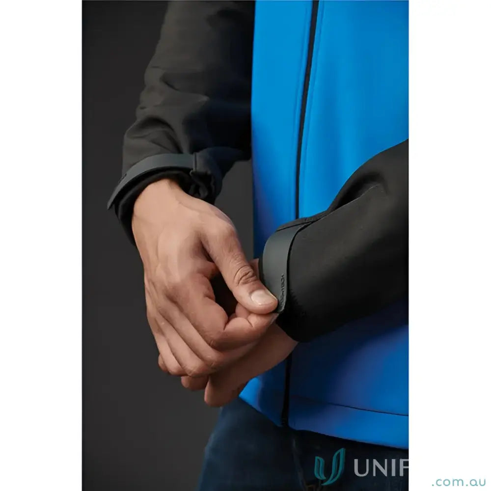 Person adjusting cuff of Cascades Softshell workwear jacket for uniforms and outdoor wear