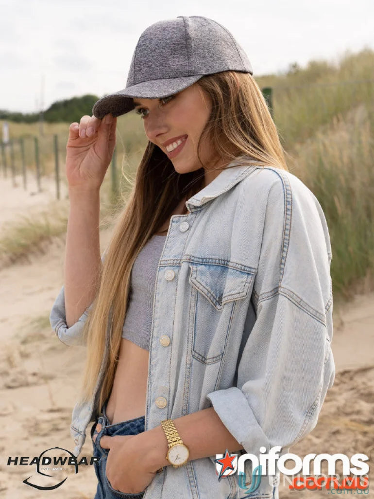 Young woman wearing Cationic Sports Jersey Cap with denim jacket, perfect for uniforms or workwear