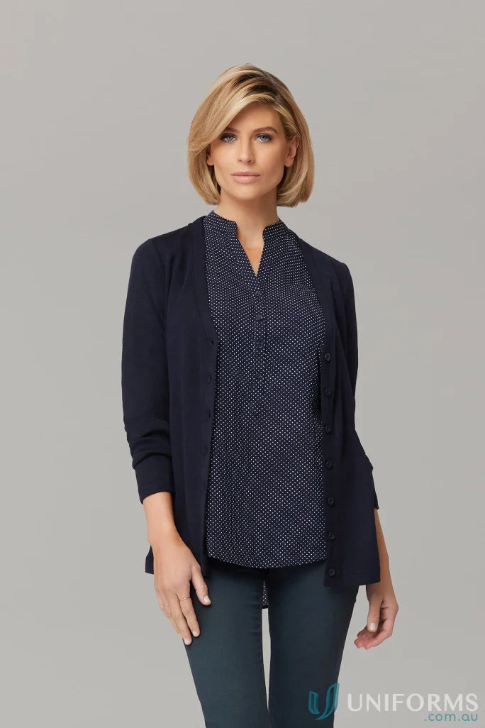 Woman wearing City Overknit navy cardigan with polka dot blouse, Australian Merino wool versatile neckline perfect for corporate wardrobe