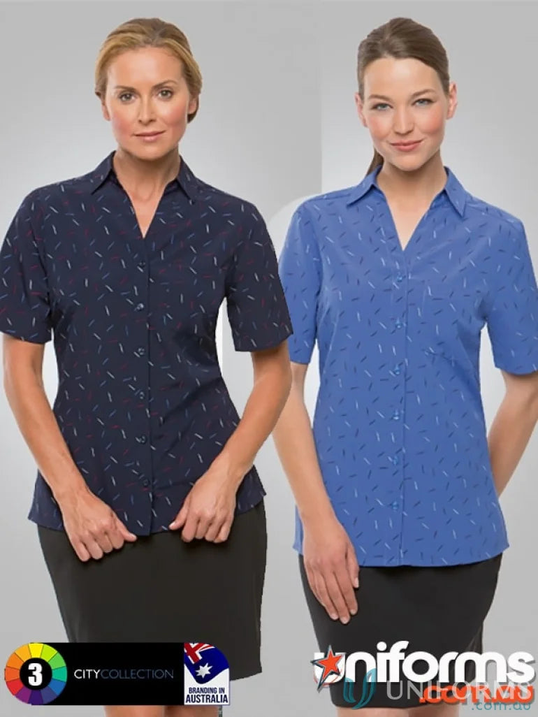 Two women modeling navy and blue City Stretch Spot Tunic with black skirts