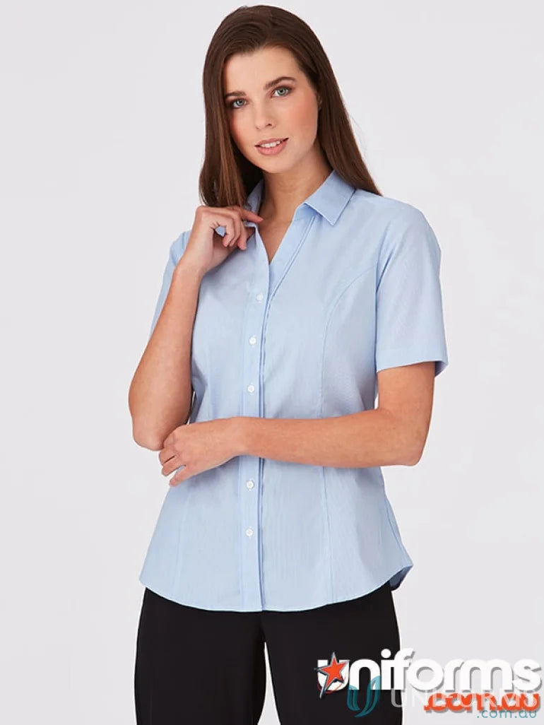 City stretch ladies SS Pinfeather woman in light blue short-sleeve collared shirt and black trousers