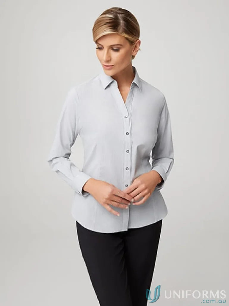 Woman in City Stretch LS Pinfeather long sleeve shirt and black pants uniform style