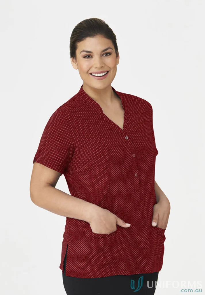 Smiling woman in City Collection spot tunic top with polka dots and black workwear pants