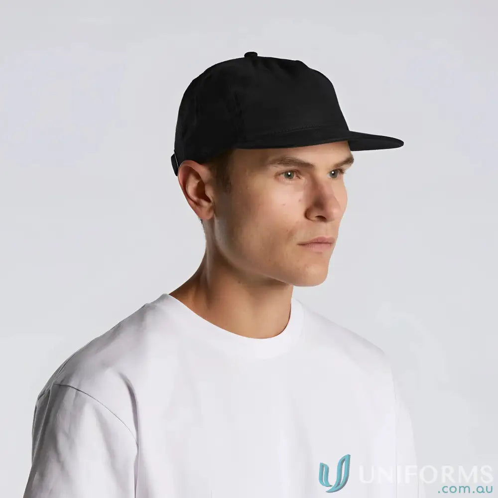 Man wearing black flat-brimmed Class Linen Cap with adjustable fastener and tonal under-peak lining