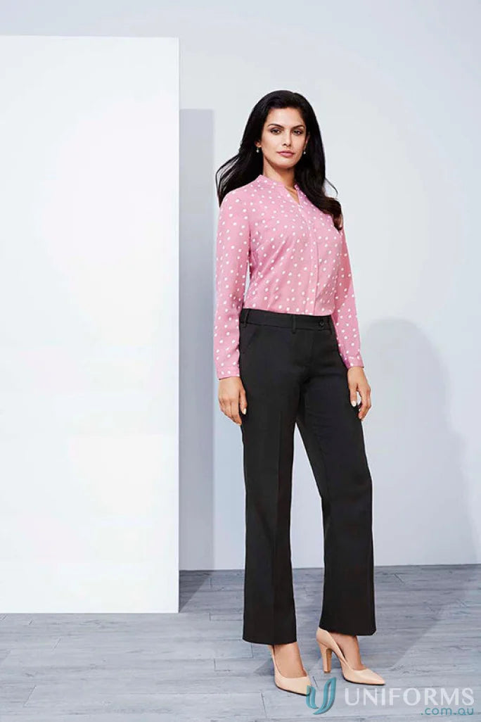 Woman in pink polka dot blouse wearing cool stretch mid rise adjustable waist pant