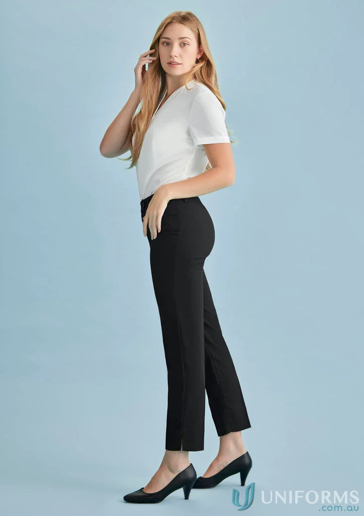 Woman in black cool stretch slim leg pants and white top for women’s cool style
