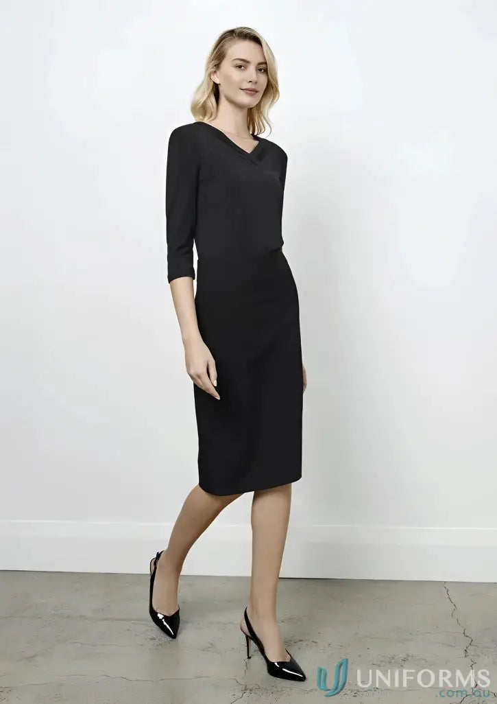 Woman modeling a comfortable black stretch fit below knee skirt with V-neck and 3/4 sleeves