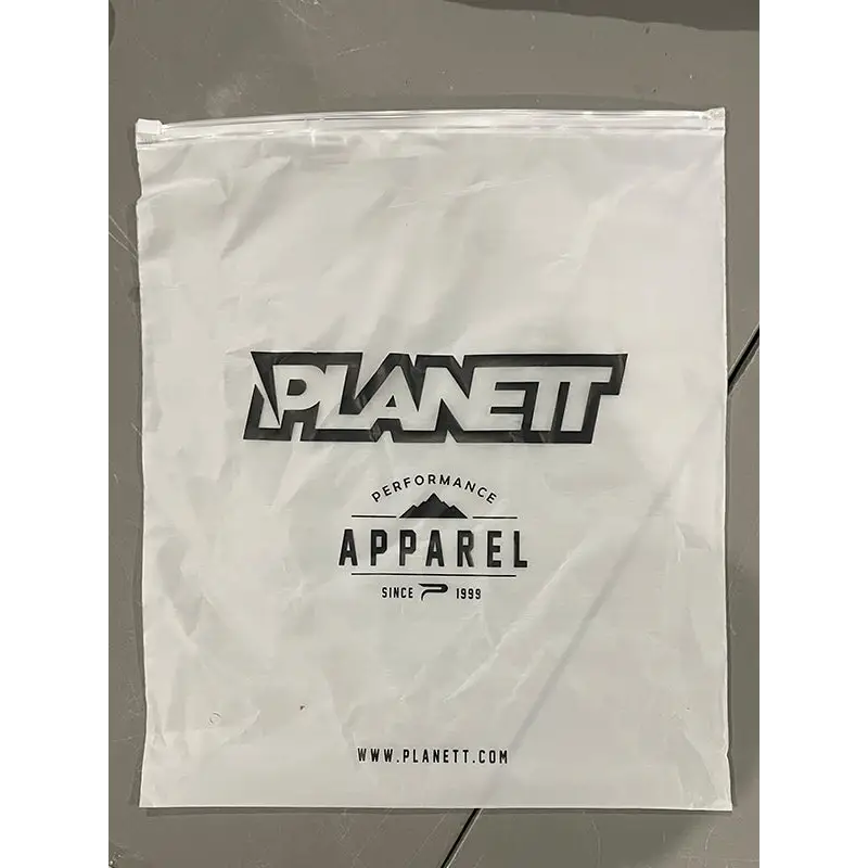 White plastic zip-top bag with black planet apparel logo and website for custom diesel mx pant workwear uniforms