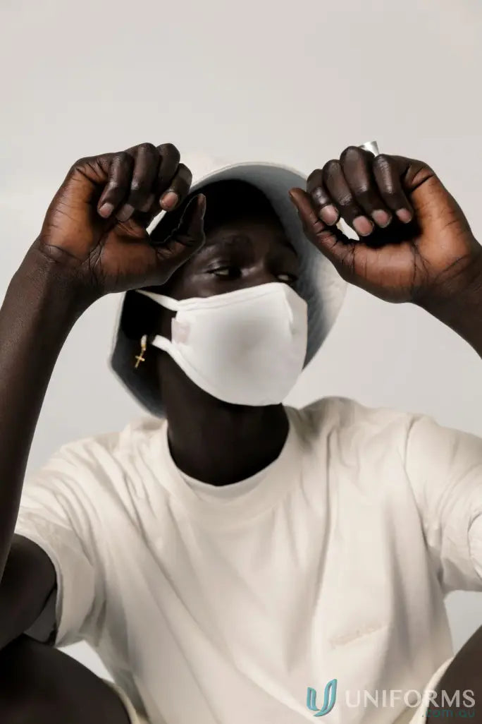 Person wearing white face mask and bucket hat with Retro Fit Donald Tee and higher ribbed neckline