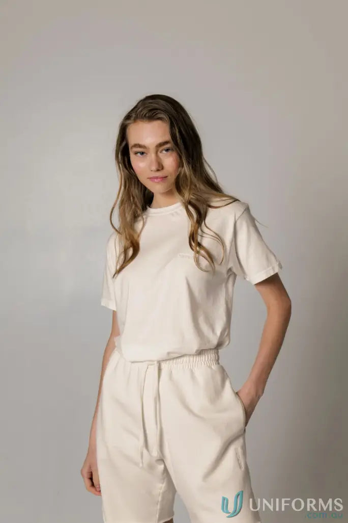 Woman in Retro Fit Donald Tee with higher ribbed neckline and matching white shorts