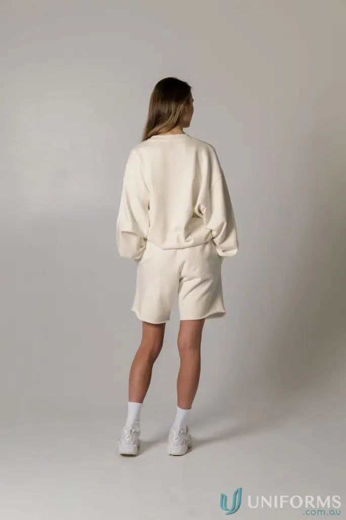 Woman in a Retro Sweat Natural Dyed oversized drop shoulder cream sweatshirt and shorts