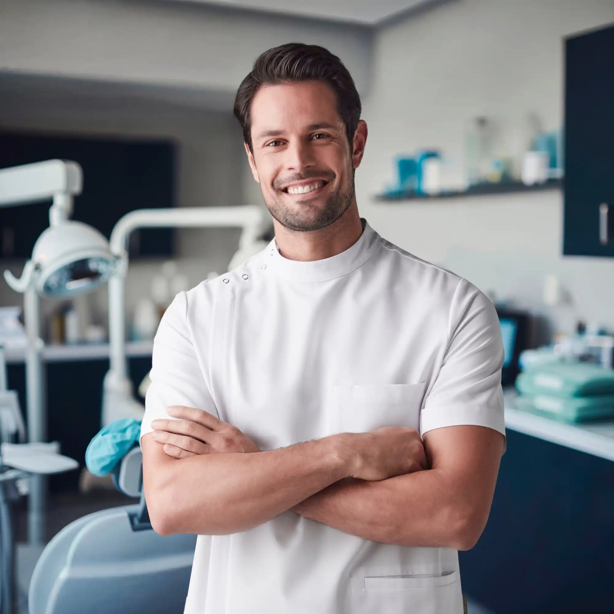 Smiling dentist with crossed arms.